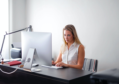 woman-in-white-sleeveless-shirt-using-macbook-air-on-brown-wooden-table-3766189